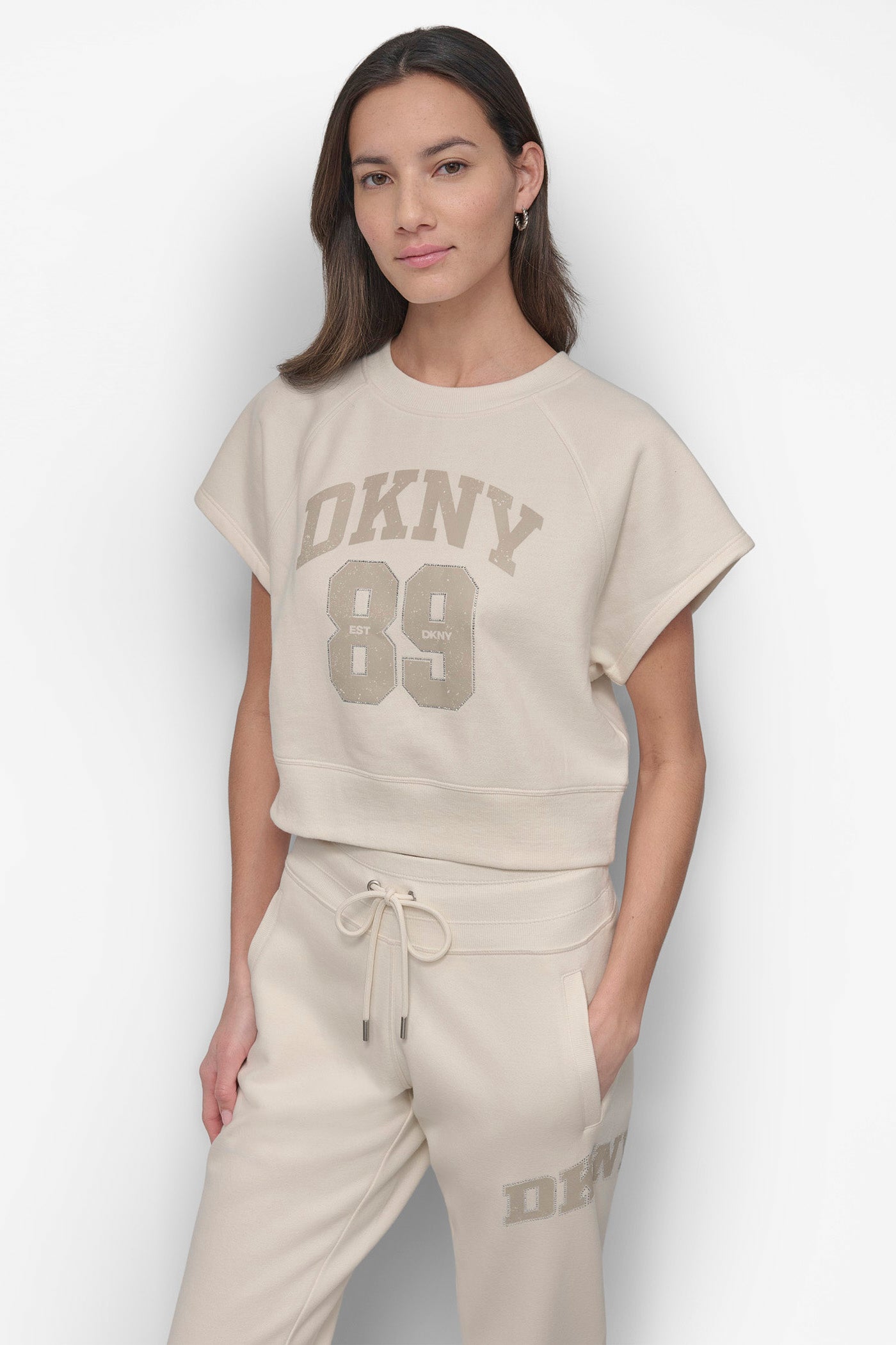 ARCHED DKNY 89 DISTRESSED RHINESTONE LOGO CROPPED