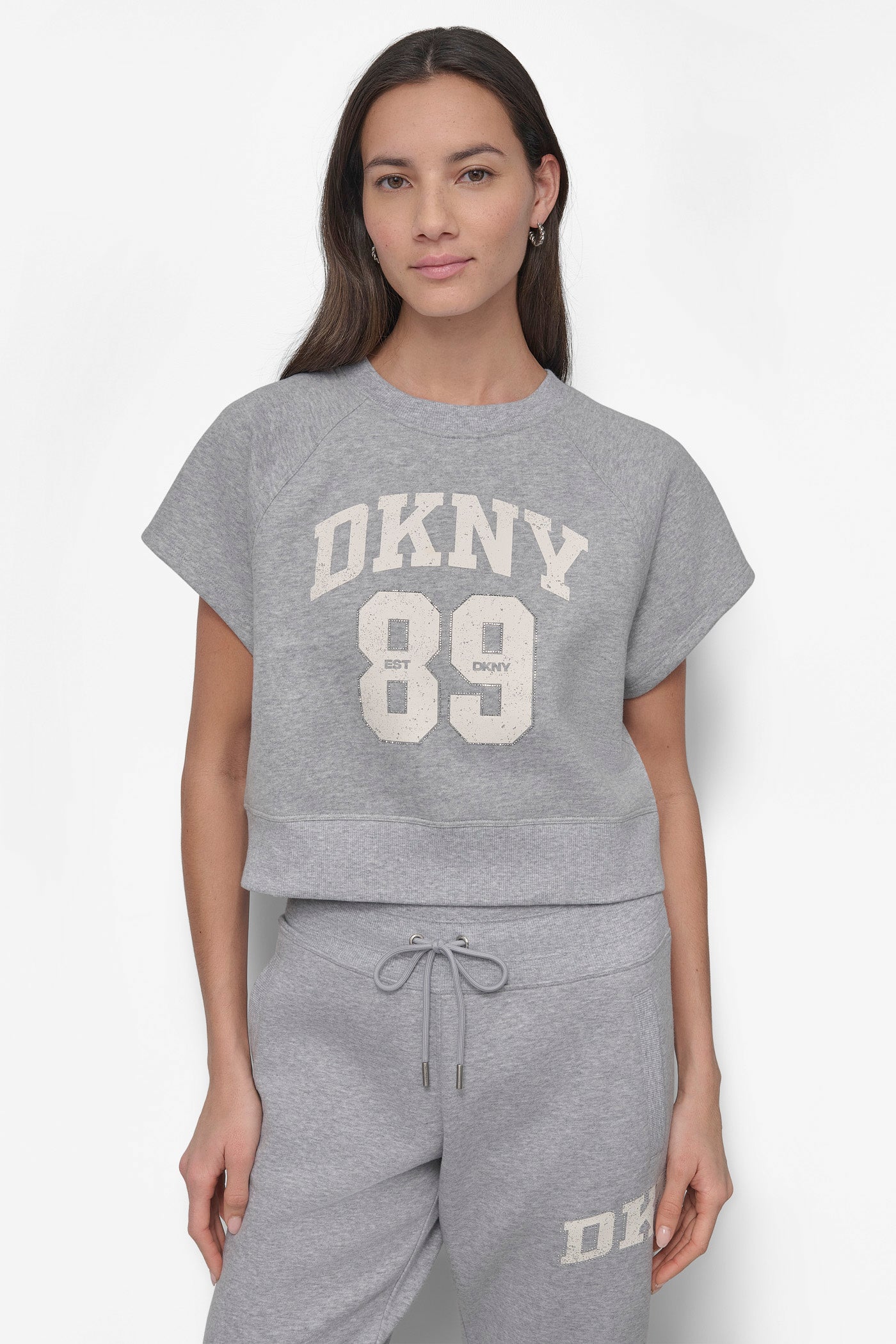 ARCHED DKNY 89 DISTRESSED RHINESTONE LOGO CROPPED